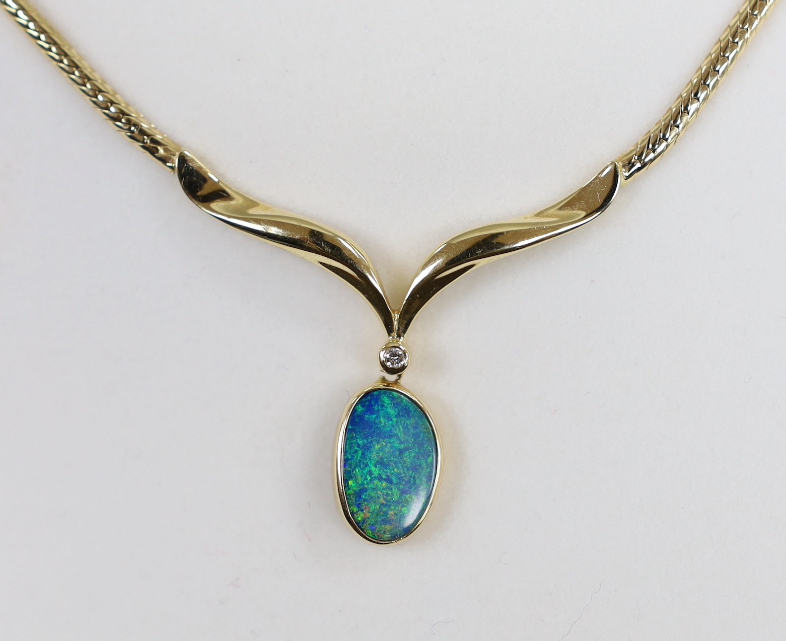 A modern 585 yellow metal and black opal doublet? and diamond set drop pendant necklace, overall 37cm, gross weight 12.5 grams.
